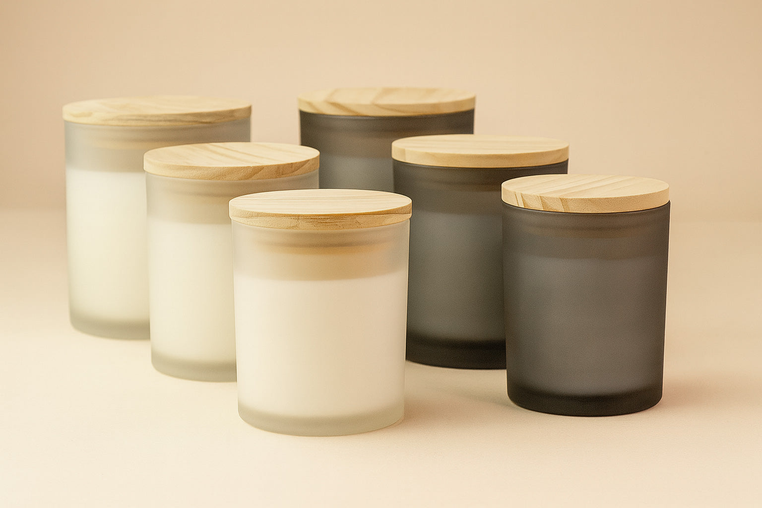 Set of glass jars with wooden lids on a beige background