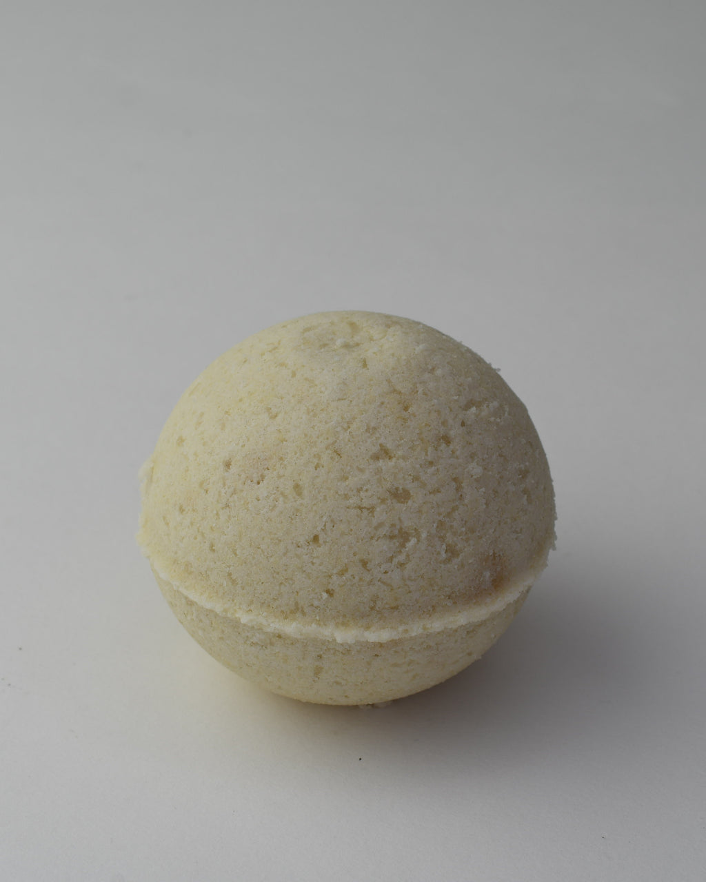 Beige bath bomb on a gray background