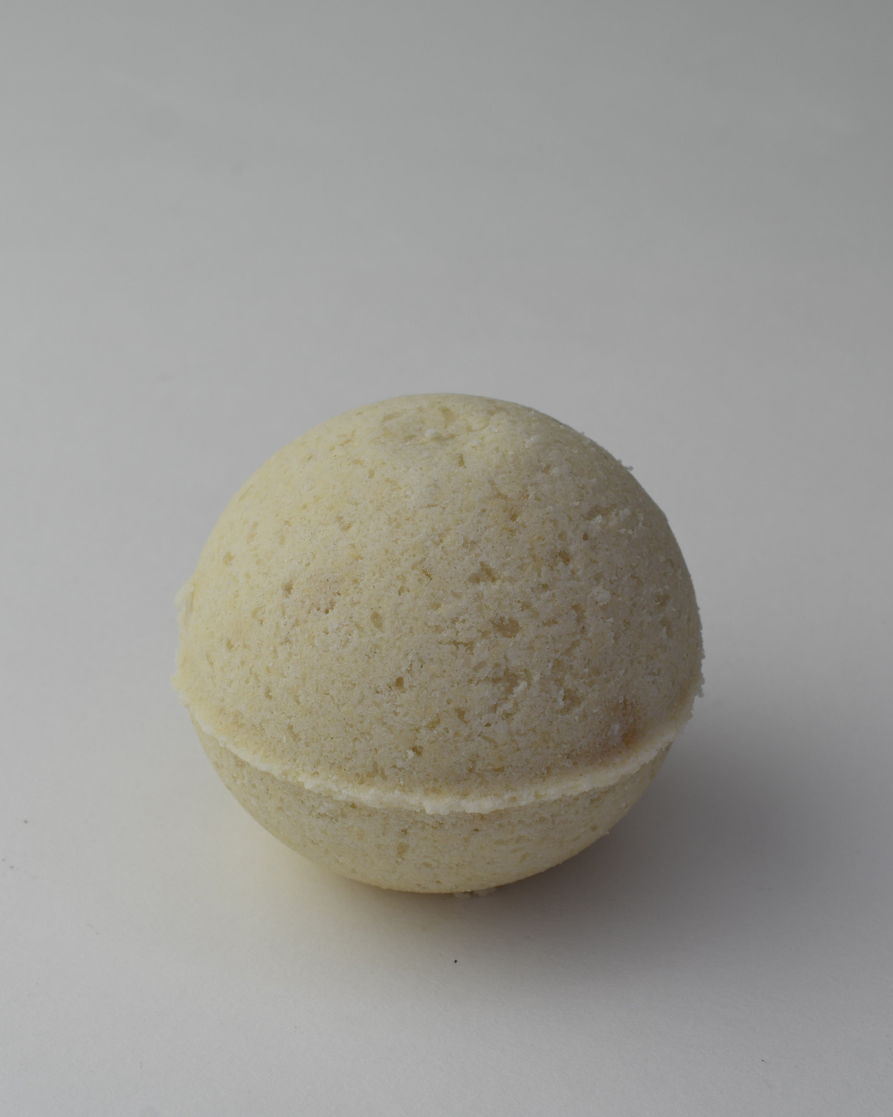 Beige bath bomb on a gray background