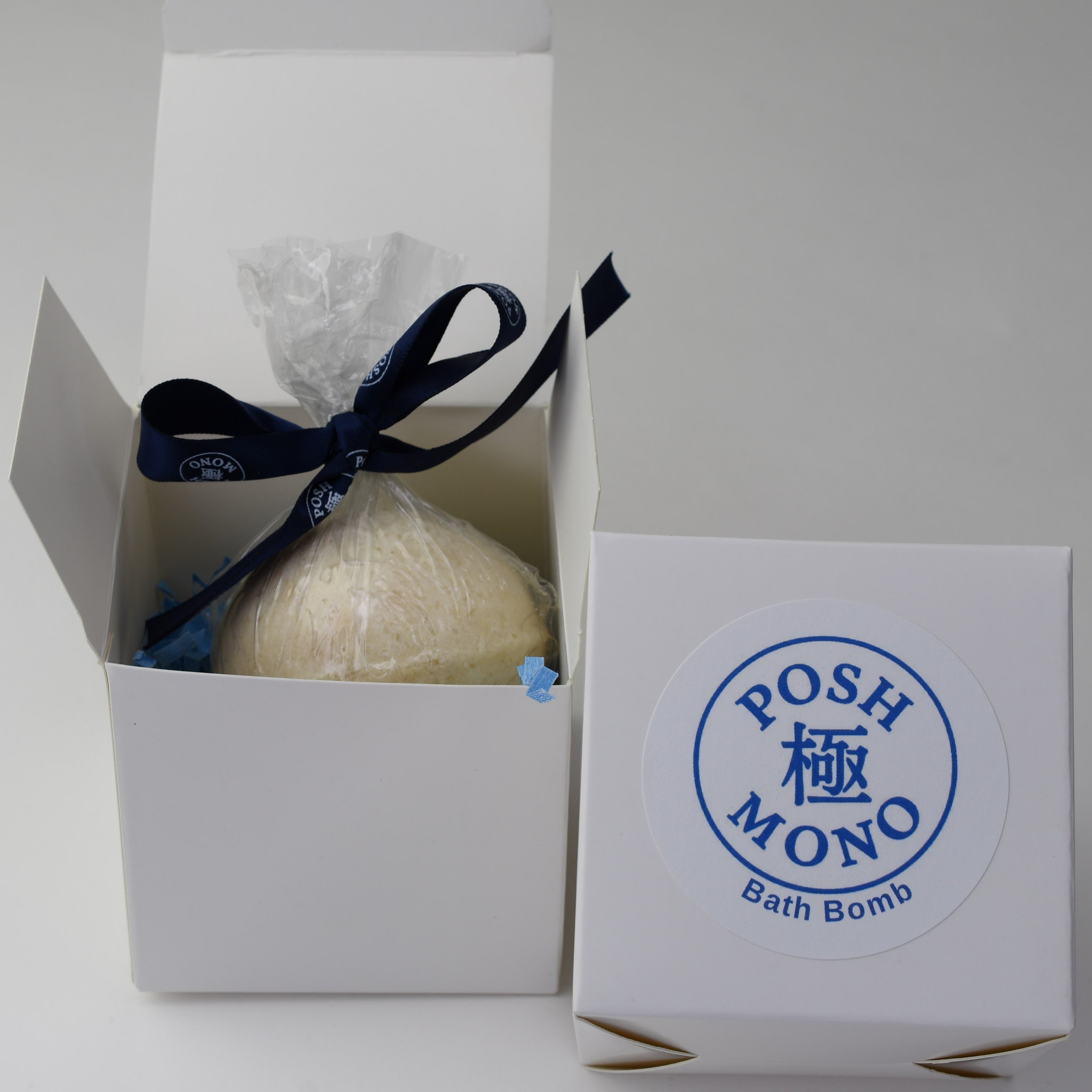 Bath bomb in a white box with 'Posh Mono' branding on a light gray background