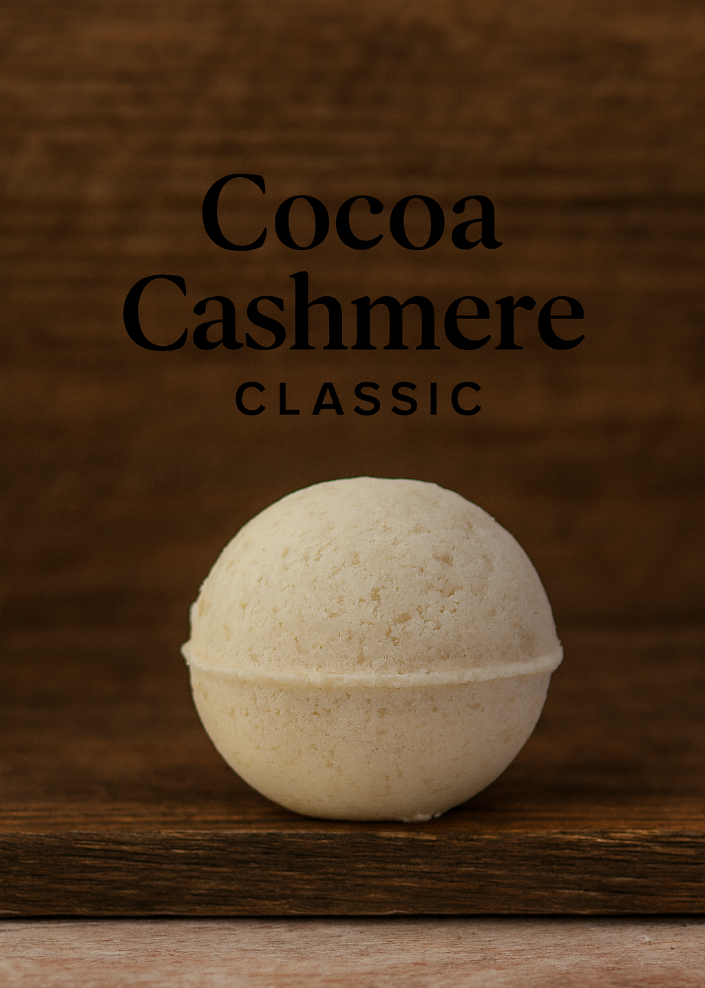 Bath bomb labeled 'Cocoa Cashmere Classic' on a wooden surface with a brown background